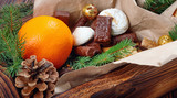 Delicious sweets, chocolates, cookies and oranges for gifts in  wooden box on  vintage table