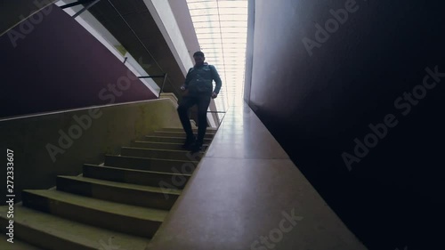 Man in dark boots and jeens descends down the stairs tourist travel city outdoors people street tourism beautiful building europe guy lifestyle urban view architecture slow motion
