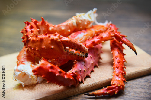 Alaskan King Crab Legs cooked seafood on wooden cutting board background - red crab hokkaido