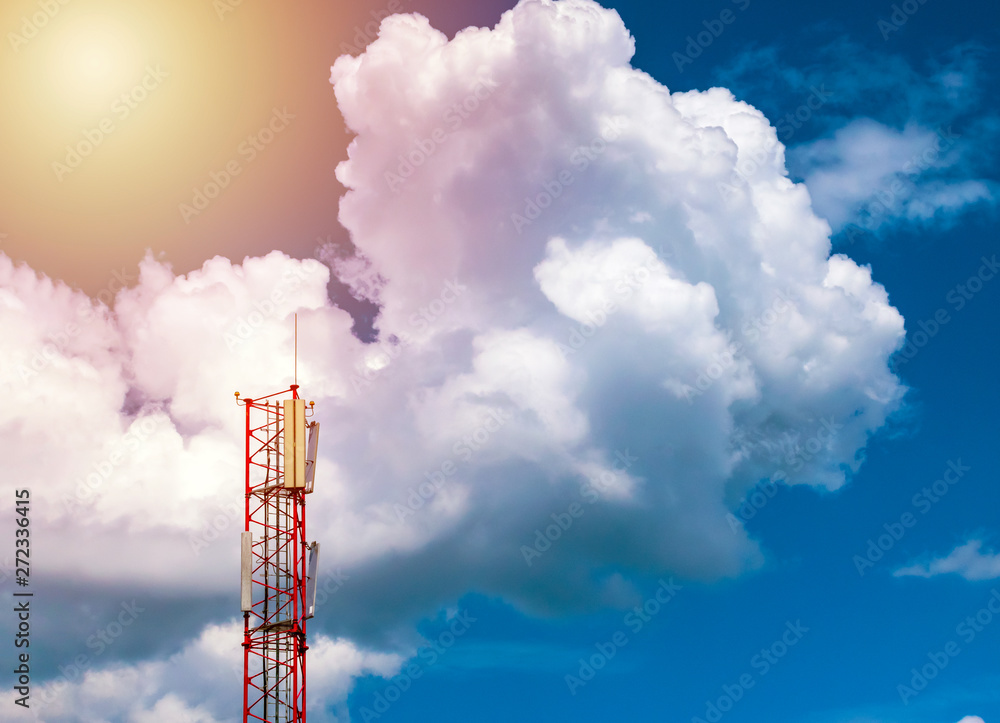communication tower on bright blue and cloudy sky background