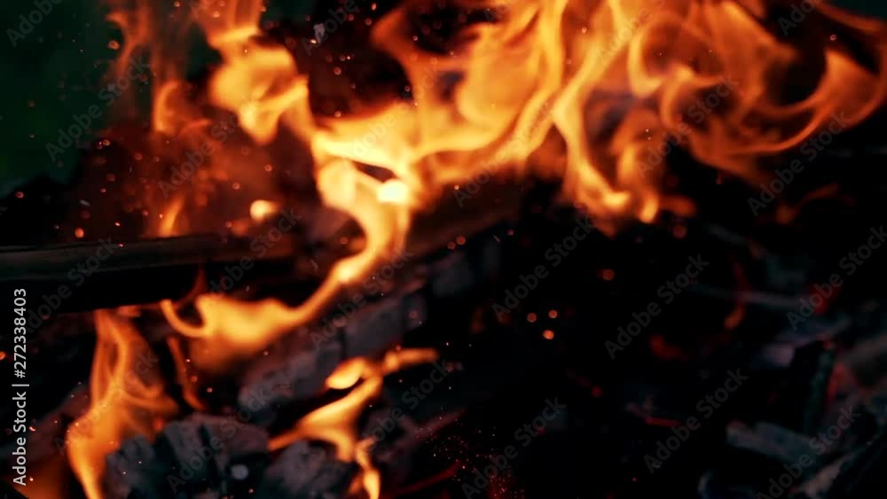 Burning Log Fire Flames in the grill. Beautiful fire burns brightly. Embers of the fire climb up. Slow motion Burning Log Fire Flames in the grill. Beautiful fire burns brightly. Embers of the fire climb up. Slow motion