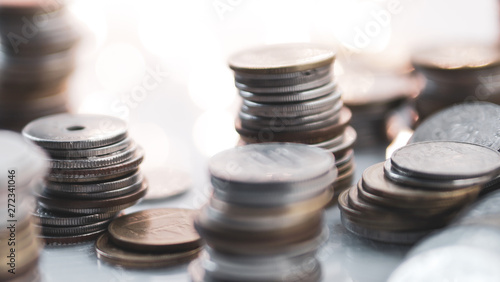 rows of money coins on light bokeh for finance , money , investment and business concept background
