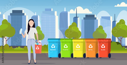 woman holding bucket with plastic rubbish near containers different types of recycling bins segregate waste sorting management concept modern cityscape background flat horizontal full length
