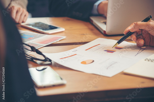 Teamwork Concept. Team meeting provides recruitment and employment services show graph of progress in conference room.
