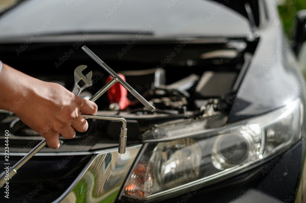 Repair service car Auto mechanic working in garage car mechanic with wrench in garage