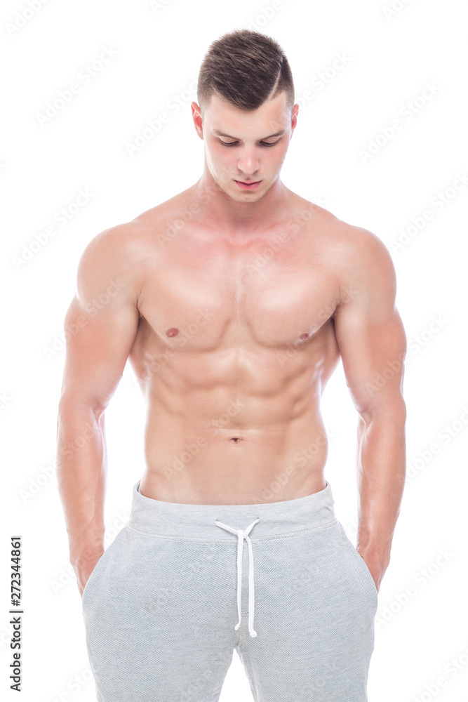 Strong Athletic Man - Fitness Model showing his perfect body isolated on white background with copyspace. Bodybuilder man with perfect abs, shoulders,biceps, triceps and chest. Strong Athletic Man - Fitness Model showing his perfect body isolated on white background with copyspace. Bodybuilder man with perfect abs, shoulders,biceps, triceps and chest.