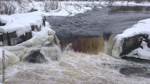 View of the waterfall Voitsky Padun, cloudy February day. Karelia, Russia photo