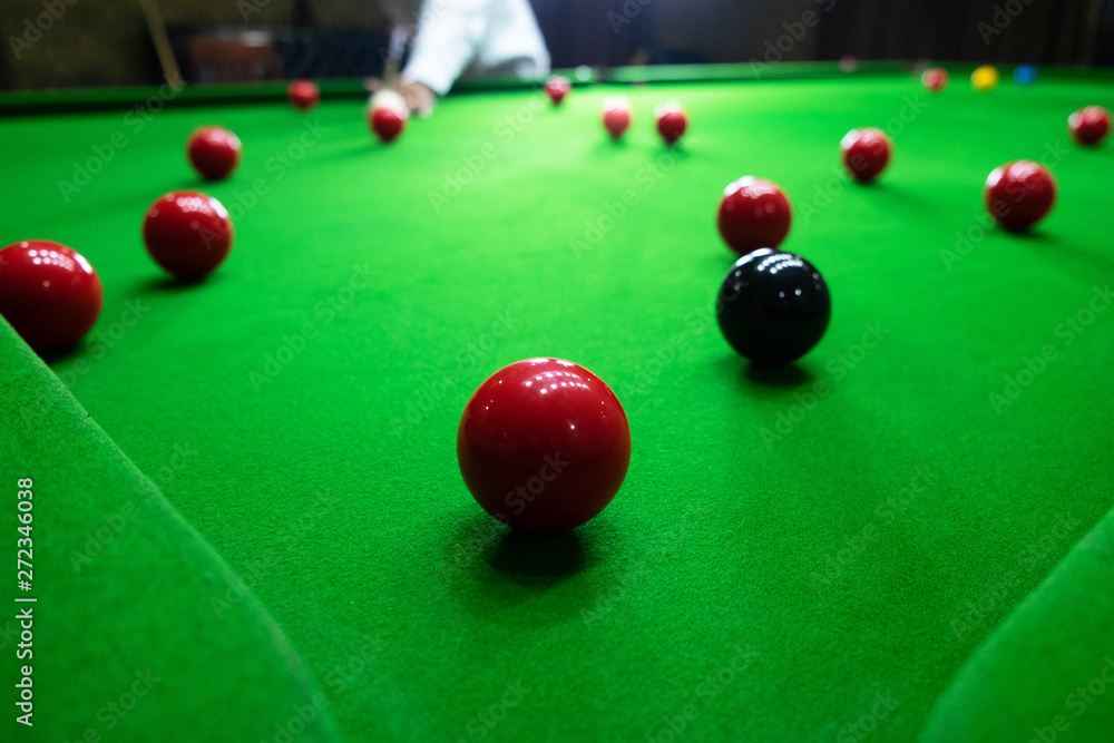 Playing snooker, piercing the red ball, black, aiming the ball and  pocketing the hole to score points. Stock Photo | Adobe Stock