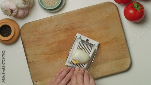 Hands cutting a hard-boiled egg on a wooden board