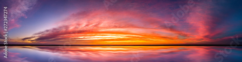 Panorama Reflection of vivid sunset sky over sea.Colorful sunrise with Clouds over ocean.  © noon@photo