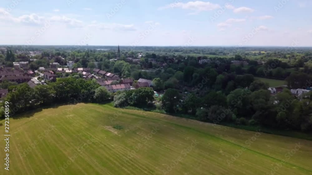 Drone flying over urban landscape in Alderley Edge, Cheshire, UK - showing suburban greenbelt and agricultural landscape, plus railway line. Drone flying over urban landscape in Alderley Edge, Cheshire, UK - showing suburban greenbelt and agricultural landscape, plus railway line.