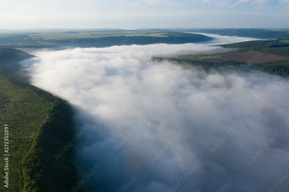 Obraz premium Canyon river in fog shooting from the air