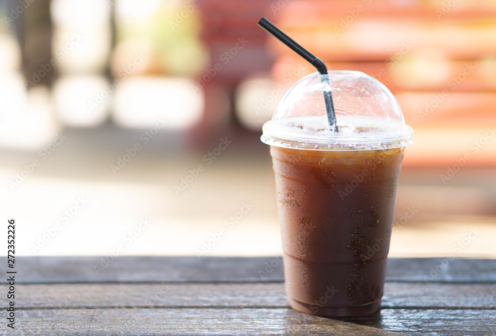 Close up glass of ice americano coffee on wood table, selective focus Close up glass of ice americano coffee on wood table, selective focus