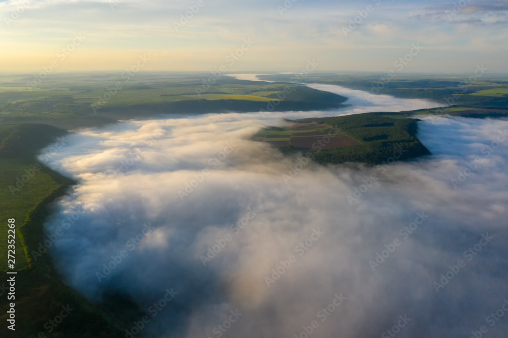 Fototapeta premium Canyon river in fog shooting from the air
