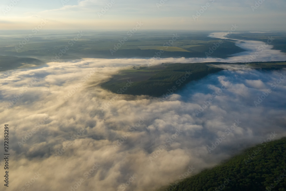 Fototapeta premium Canyon river in fog shooting from the air