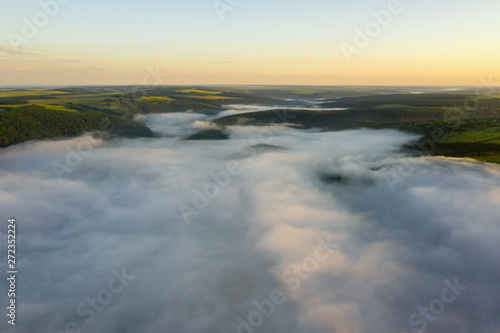 Canyon river in fog shooting from the air © slava2271