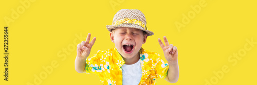 Child in yellow hawaiian shirt and straw hat shouts