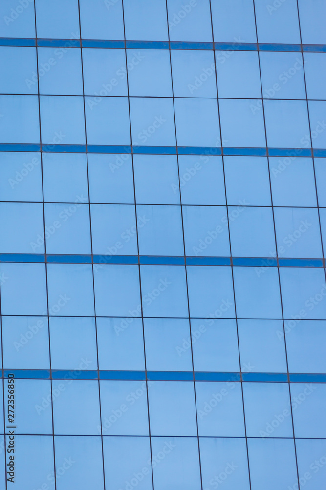 Blue glass windows of office building Blue glass windows of office building