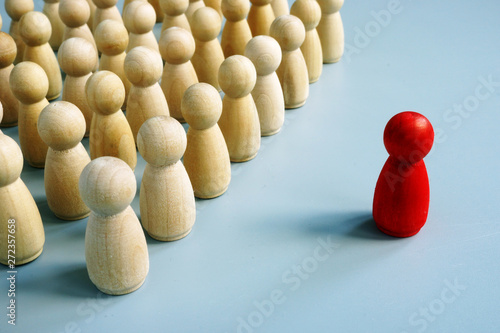 Successful leader of team as red figurine out of the crowd.