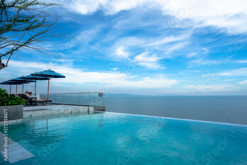 Pattaya, Thailand Luxury - June 3, 2019: swimming pool and blue water at the resort with beautiful sea view at u jomtien pattaya. Seaside pool