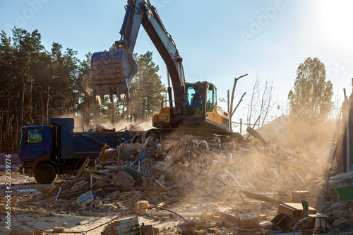 Excavator demolishing building photo