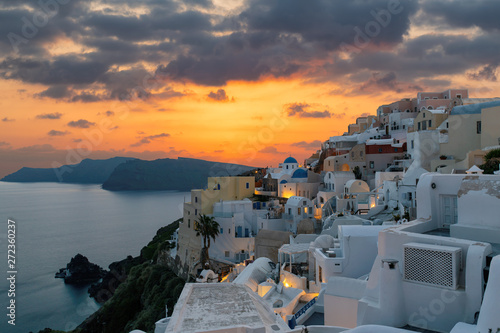 Sunset at blue domed churches on Santorini Greek Island, Oia town, Santorini, Greece.