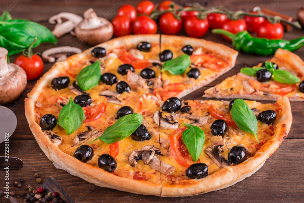Tasty fresh hot pizza against a dark background. Pizza, food, vegetable, mushrooms Tasty fresh hot pizza against a dark background. Pizza, food, vegetable, mushrooms