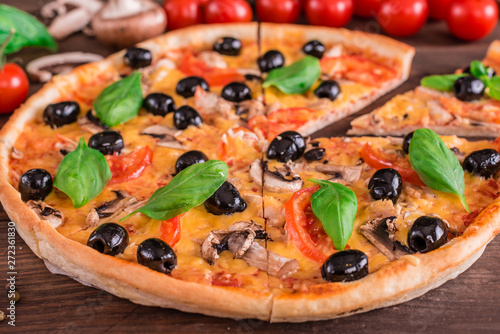 Tasty fresh hot pizza against a dark background. Pizza, food, vegetable, mushrooms