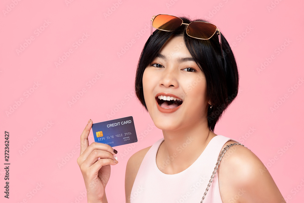 Young pretty Asian woman with credit card in hand Young pretty Asian woman with credit card in hand