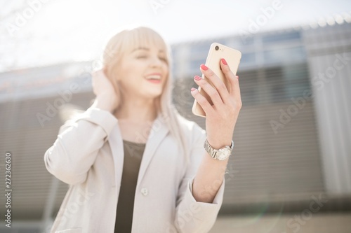 Portrait of a young girl holding a mobile phone.