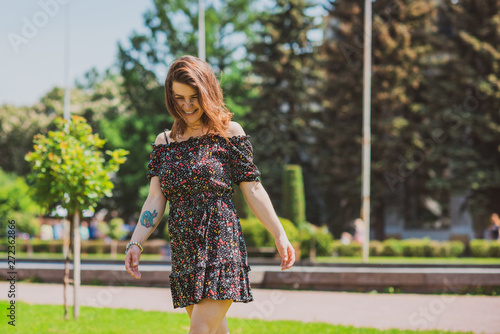 Happy smiling woman enjoy the life and having fun at city park. Summer sunny days and good mood 