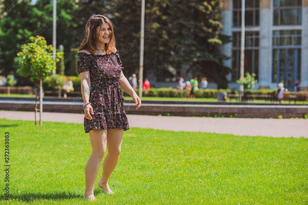 Happy smiling woman enjoy the life and having fun at city park. Summer sunny days and good mood Happy smiling woman enjoy the life and having fun at city park. Summer sunny days and good mood