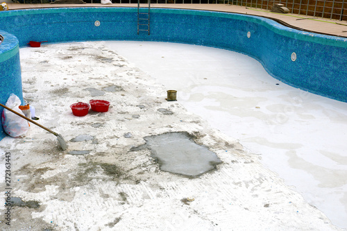 Swimming pool remodel. Laying construction of the swimming pool in the garden. New swimming pool construction site.