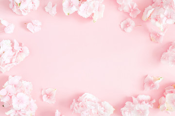 Flowers composition. Hydrangea flowers on pastel pink background. Flat lay, top view, copy space