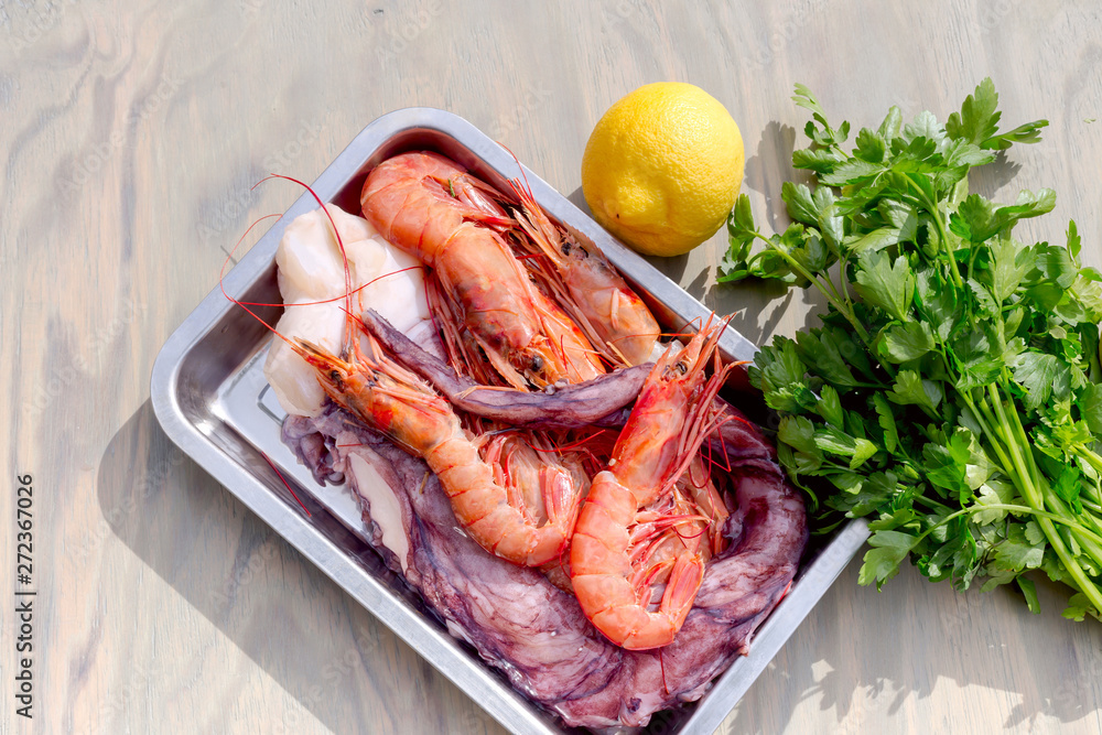 Shrimps and legs of an octopus on a tray Shrimps and legs of an octopus on a tray