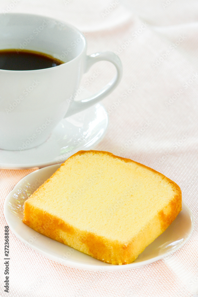 Piece of butter cake on white dish served with cup of black coffee. Times to relax concept. Piece of butter cake on white dish served with cup of black coffee. Times to relax concept.