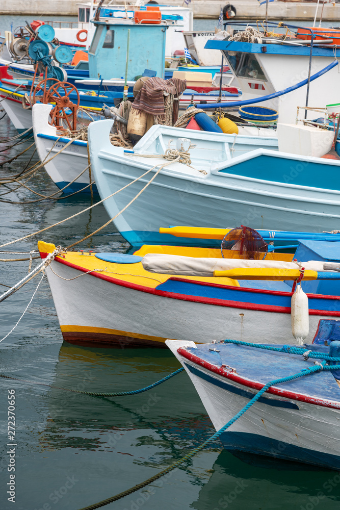 Boats in small Aegean sea port in Greece.