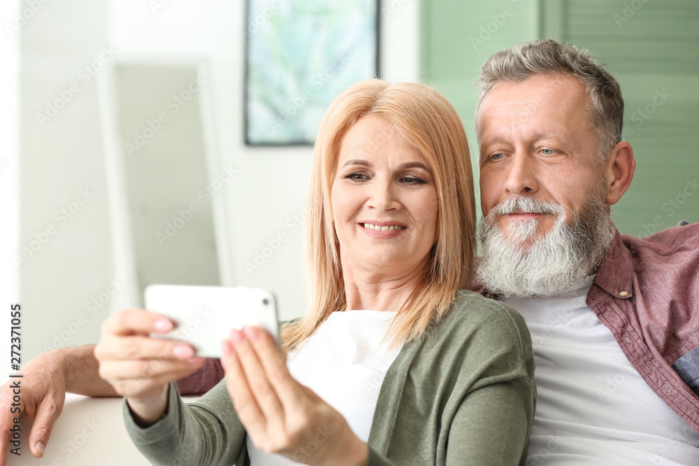 Happy elderly couple taking selfie at home Happy elderly couple taking selfie at home