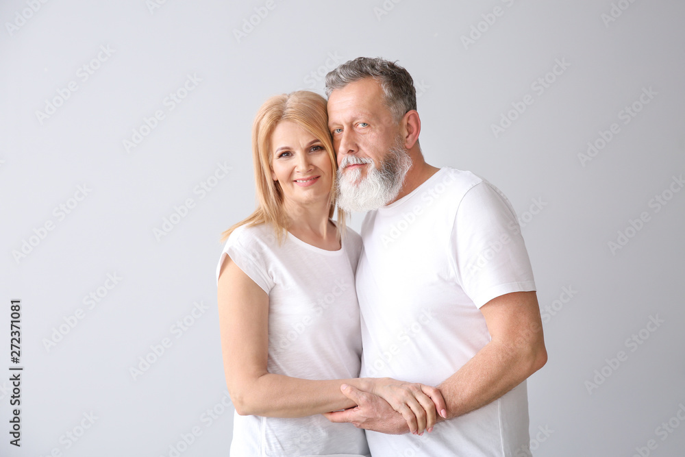 Beautiful elderly couple on light background Beautiful elderly couple on light background