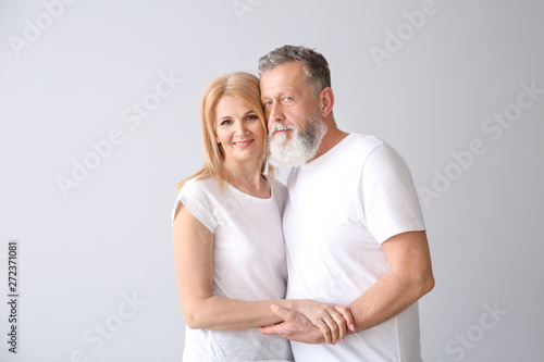 Beautiful elderly couple on light background