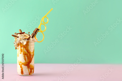 Delicious freak shake on color background photo