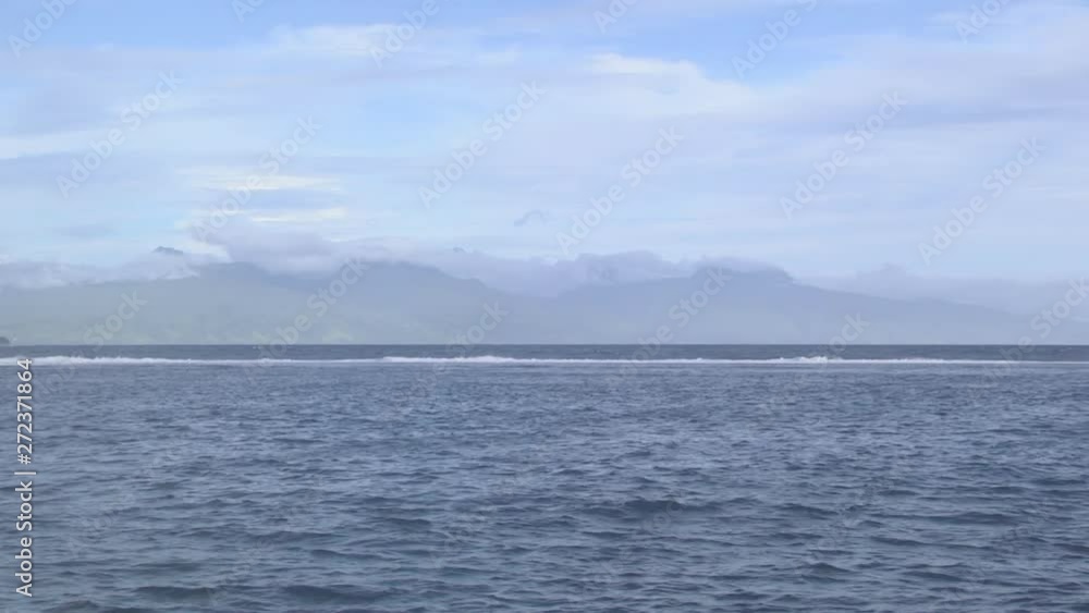 Waves Breaking Off Shore in Polynesia With Clouds in Background Waves Breaking Off Shore in Polynesia With Clouds in Background