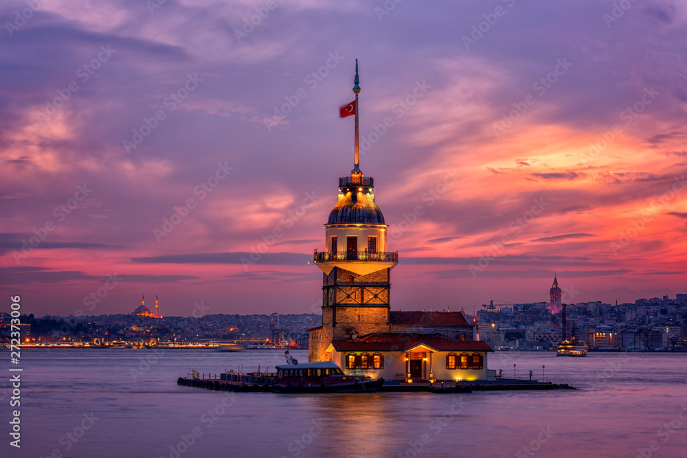 Fototapeta premium Fiery sunset over Bosphorus with famous Maiden's Tower (Kiz Kulesi) also known as Leander's Tower, symbol of Istanbul, Turkey. Scenic travel background for wallpaper or guide book