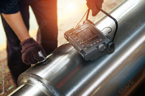 Technicians use flaw detectors to detect cracks or defects in metal pipes