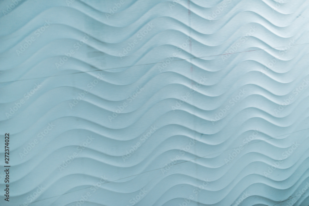 Wavy pattern on a light blue wall. Wavy pattern on a light blue wall.