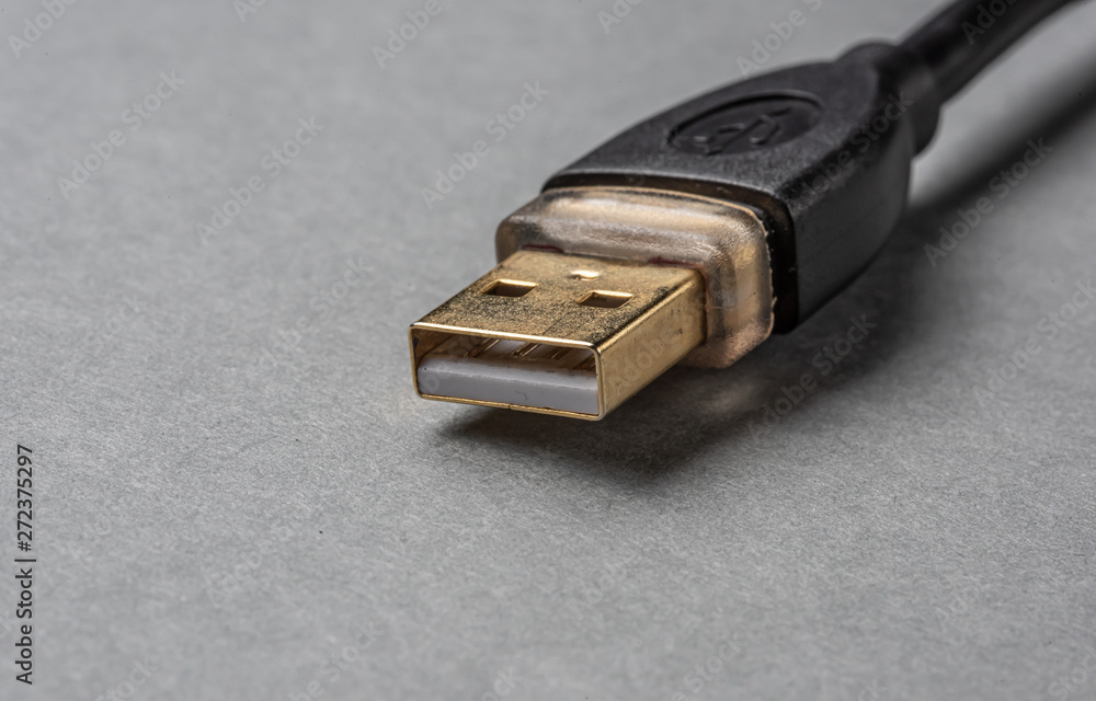 Gold USB-plug on grey background Gold USB-plug on grey background