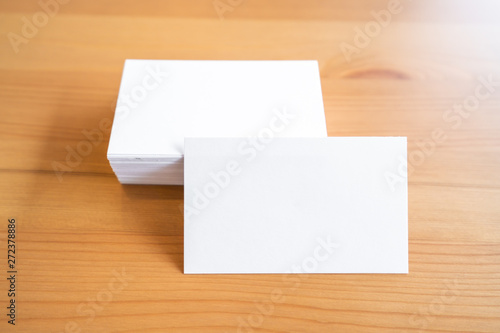 Blank business cards on wooden surface