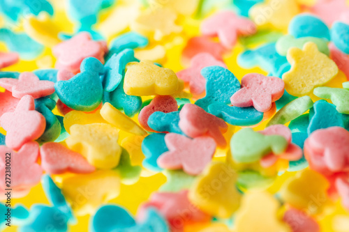 multicolored candy on a yellow background 