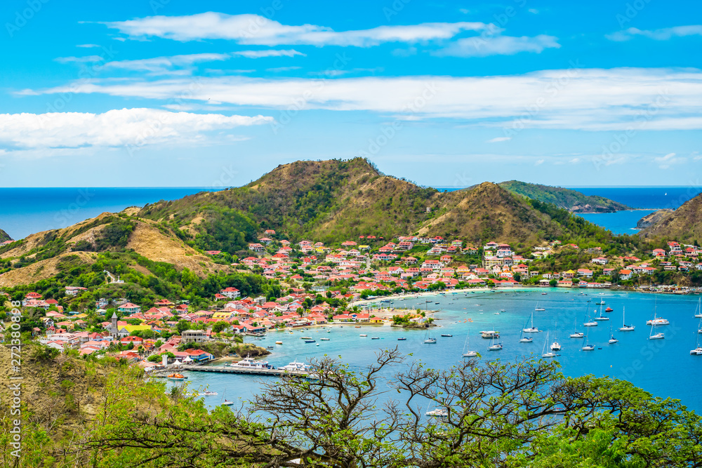 Terre-de-Haut, Guadeloupe.  Colorful landscape with village, bay and mountains.