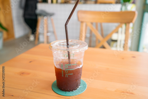 Ice americano coffee on wooden table